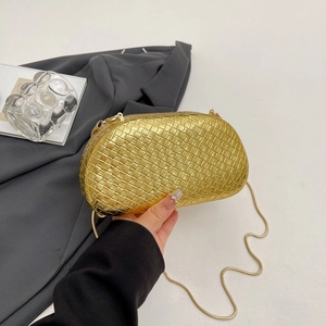 Detailed view of the luxury gold woven evening bag with elegant metal chain strap