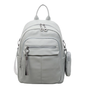 Detail of light blue faux leather backpack with litchi grain texture and coin purse