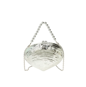Close-up of silver shell evening bag with metallic finish and pearl beaded handle