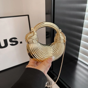 Gold metallic crescent handbag with pleated texture and circular handle for evening wear