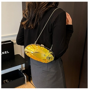 Detailed back view of a golden irregular metallic shell evening bag with a chain strap