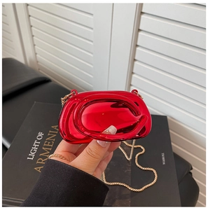 Detail of red metallic mini bag with circular bead chain and sleek round top handle