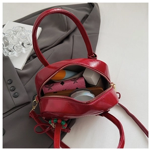 Top view of red patent leather pillow bag showing spacious interior with daily essentials