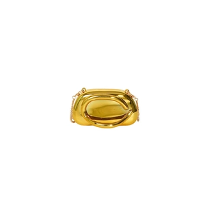 Close-up of golden acrylic evening bag with mirror finish and elegant metal chain