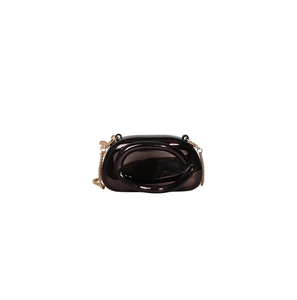 Detail of dark brown glossy patent leather bag with gold chain and circular handle