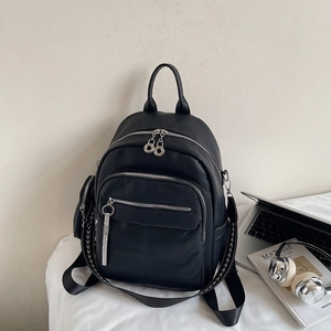 Black faux leather backpack with litchi texture and patterned shoulder strap