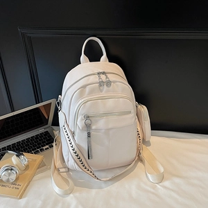 White pebbled leather backpack with woven straps for travel and school commute