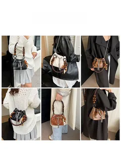 Three PU leather drawstring bucket bags with wooden bead handles and metal tassels