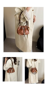 Detail of caramel PU bucket bag featuring wooden bead handle and metal chain strap