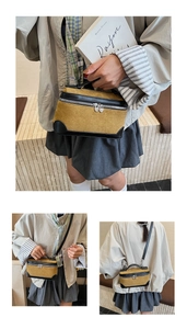 Détail du sac bandoulière en daim avec zips en cœur et options de portage multiples