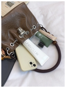 Interior view of vintage brown bucket bag showing storage for cosmetics and accessories