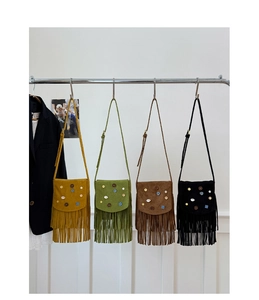 Detail view of retro tassel crossbody bags in yellow, green, brown, and black colors