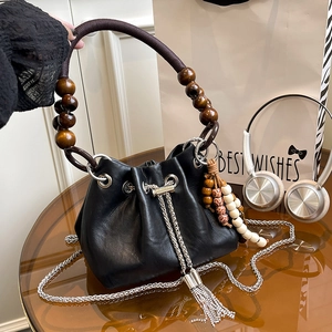Retro black leather bucket bag with beaded rope handle and sparkling diamond tassels