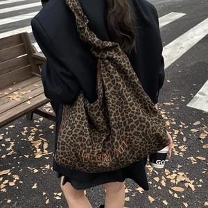 Large leopard print tote bag with DOERIVALIS embroidery shown in a street fashion style