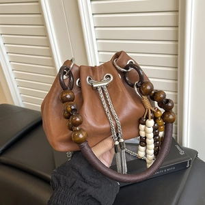Vintage brown PU bucket bag with unique wooden bead handle and tassel details