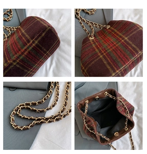 Detail view of vintage plaid tote bag with metal chain strap and magnetic closure