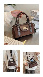 Gros plan d'un sac Boston vintage marron avec breloque coeur et coutures en cuir raffiné
