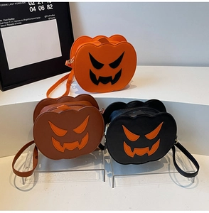Three pumpkin-shaped crossbody bags in orange, brown and black with Jack-o'-lantern faces