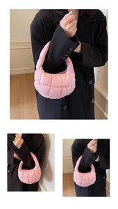 Detail view of pink quilted puffer bag with square stitching and cloud texture