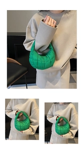 Detail of bright green quilted puffy tote bag with soft stitched cloud-like texture
