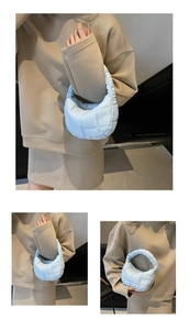 Detailed views of light blue quilted puffer handbag with cloud-like texture and zipper closure