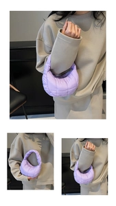Detail of lavender quilted crescent bag showing the soft puffer nylon texture and stitching