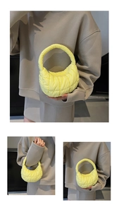 Detail of bright yellow quilted cloud handbag featuring soft padded texture and zipper closure