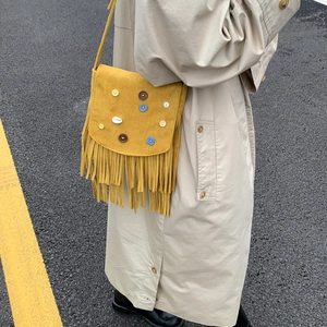 Bohemian mustard yellow suede bag with fringe and decorative buttons on shoulder strap