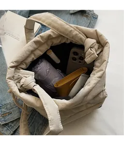 Top view of spacious nylon bucket bag interior with umbrella and phone storage