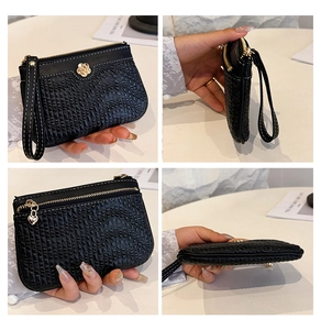 Detailed views of a black pleated leather wallet with gold floral clasp and heart charm