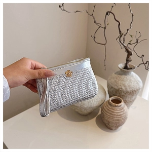 Close-up of silver PU leather wallet with woven texture and gold camellia logo decoration