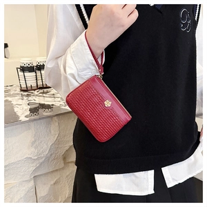 Red embossed leather mini wallet with gold camellia buckle and wristlet strap