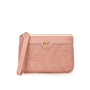 Detail of light pink coin purse with wavy texture and golden camellia flower decoration
