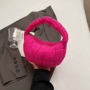 Magenta quilted puffer handbag with pleated cloud design and integrated handle for winter