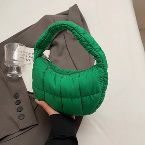 Quilted emerald green crescent handbag with a puffy cloud texture and metallic zipper