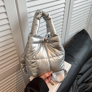 Quilted metallic silver puffer tote bag with puffy handles and modern glossy finish