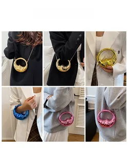 Mini metallic crescent bag in various colors shown as crossbody and clutch with chain