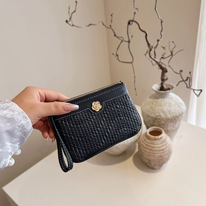 Elegant black short wallet with pleated texture and golden camellia flower buckle detail