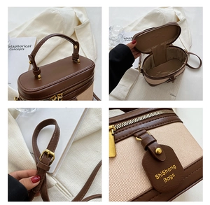 Dettaglio borsa vintage che mostra la trama della pelle marrone e le cerniere dorate