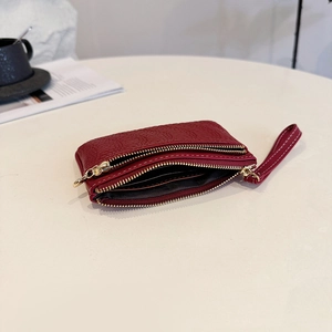 Burgundy embossed leather short wallet with double zippers and golden hardware