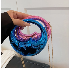 Detail of blue and pink melting moon handbags with liquid metallic finish and gold chains