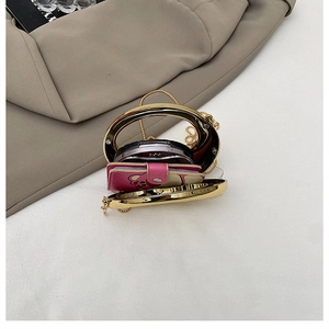Detail view of mini evening bag interior showing capacity for wallet and mirror