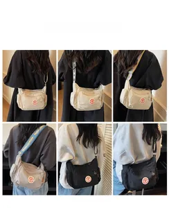 Detail view of multi-pocket nylon crossbody bag with stylish patterned adjustable straps
