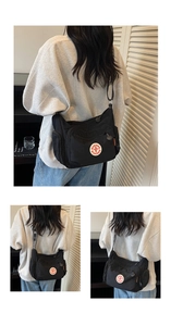 Detail view of black nylon crossbody bag featuring multi-pocket design and adjustable strap