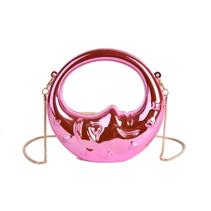 Pink metallic moon-shaped evening handbag with crescent face relief and gold chain strap