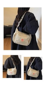 Detailed view of beige multi-pocket crossbody bag with logo and printed wide strap