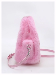 Detail of pink faux fur handbag with soft texture and silver metal strap hooks