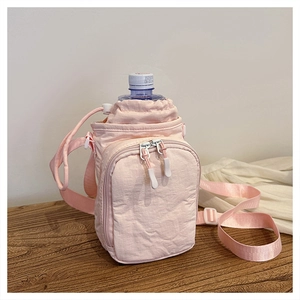 Close-up of pink nylon crossbody water bottle bag with front zipper pocket and strap