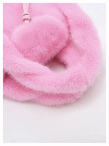 Close-up of soft pink faux fur texture and matching leather handle on the handbag