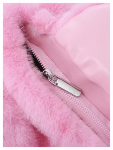 Close-up of pink faux fur texture and silver zipper detail on a designer handbag
